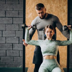 Woman doing workout at the gym with trainer